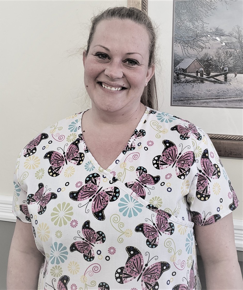 Personal support worker smiling in butterfly printed uniform